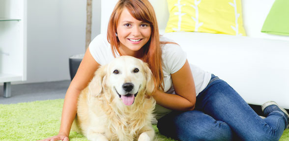 woman sitting on floor with dog